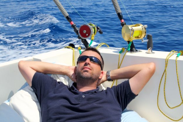 8139715 – sailor man fishing resting in boat summer vacation blue sea